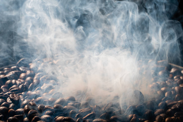 Coffee beans roasting with smoke,  selective focus, and soft focus. - Foto, immagini
