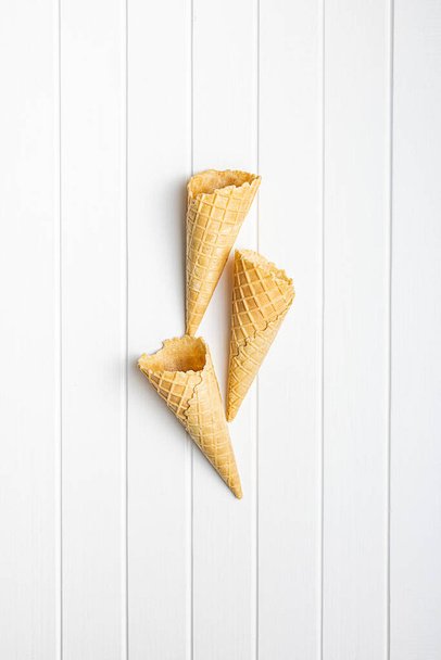 Empty wafer cone. Sweet ice cream cornet on the kitchen table. Top view. - Fotografie, Obrázek