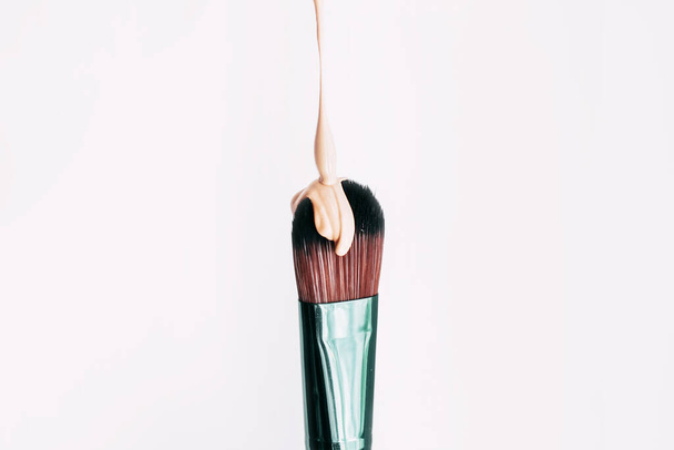 Makeup brush close-up with foundation on it. - Foto, imagen