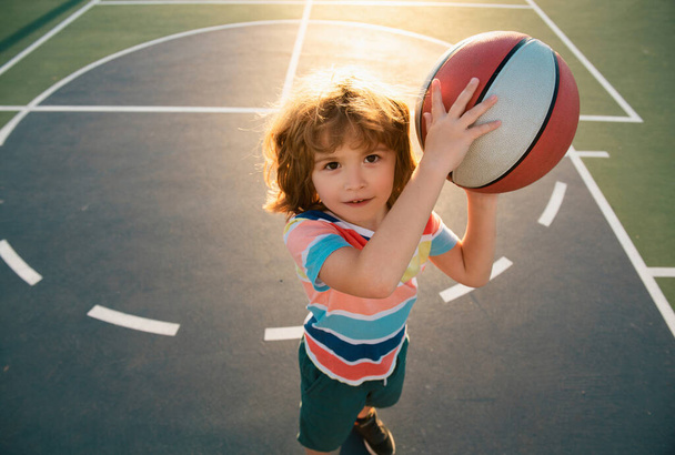Child boy preparing for basketball shooting. Active lifestyle. Basketball kids school - Φωτογραφία, εικόνα