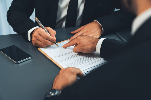 Closeup hand signing contract document with pen, sealing business deal with signature. Businesspeople finalizing business agreement by writing down signature on contract paper. Fervent - Photo, Image