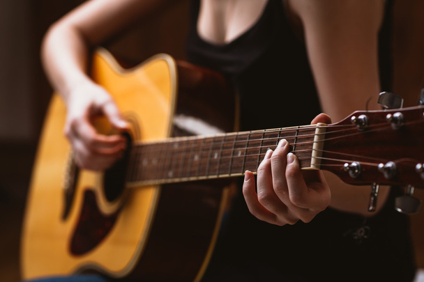 woman's hands playing acoustic guitar, close up - Fotó, kép