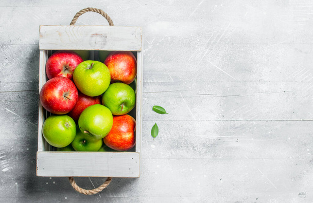 Juicy fresh green and red apples in a wooden box.On white rustic background. - Fotografie, Obrázek
