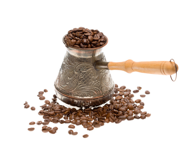 Cezve with freshly roasted coffee beans over white background - Фото, зображення