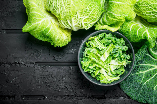 Cabbage salad in a bowl. On black rustic background. - Photo, image