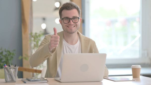 Thumbs Up by Young Businessman on Laptop - 写真・画像