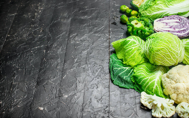 Different fresh cabbage. On rustic background - Foto, afbeelding