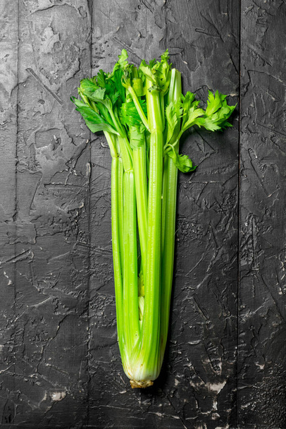 Fresh green celery. On rustic background - Fotoğraf, Görsel