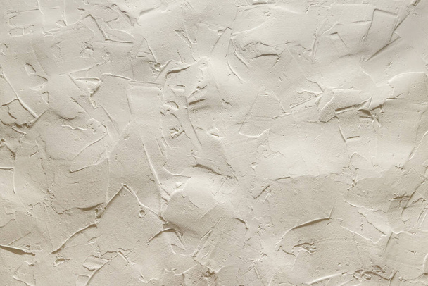 The uneven surface of a beige clay wall. High quality photo - Foto, afbeelding