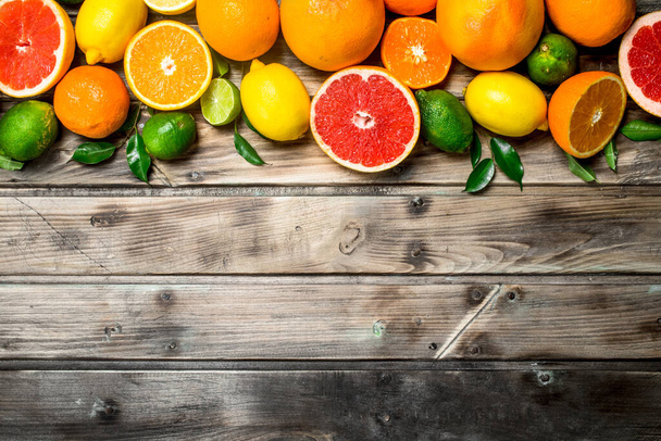 Ripe juicy citrus with leaves. On wooden background - Φωτογραφία, εικόνα