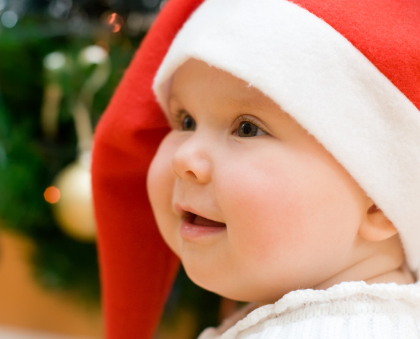Little girl in red Santa hat - Фото, изображение