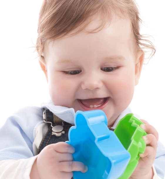 Portrait of adorable happy blue-eyes baby boy playing with toys - 写真・画像