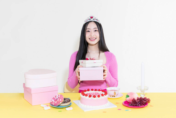vintage y2k pink retro concept photo of korean asian cute woman in birthday party concept against studio background - Photo, Image