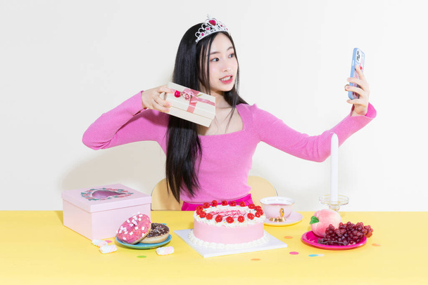 vintage y2k pink retro concept photo of korean asian cute woman in birthday party concept against studio background - 写真・画像