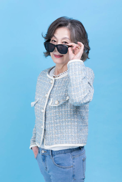 active young senior Korean Asian woman wearing sunglass - Fotó, kép