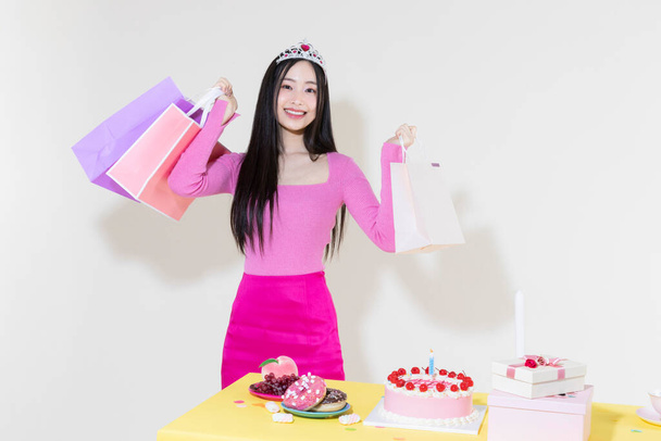 vintage y2k pink retro concept photo of korean asian cute woman in birthday party concept against studio background - Photo, Image