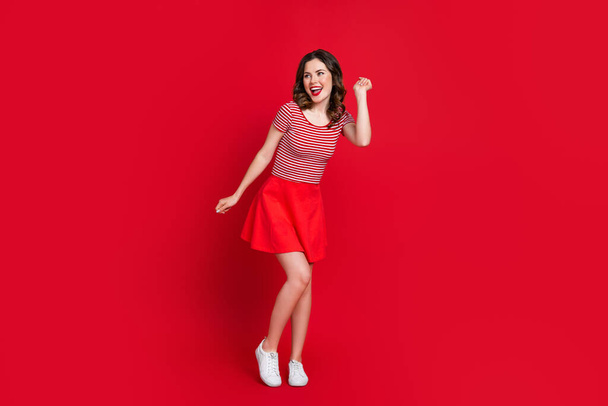 Full length photo of optimistic pretty lady have fun rejoice low prices clothes new collection empty space isolated on red color background. - Foto, Imagem