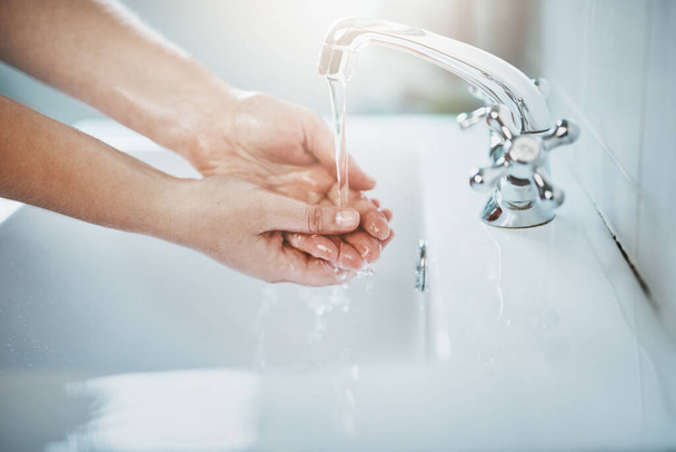 Woman, clean and washing hand with water at home for wellness, cleaning and hygiene in sink. Wash, hands and skincare to remove bacteria for self care, disinfection, health and safety at a house - Photo, Image