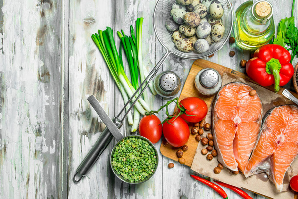 Healthy food. Salmon steaks with organic food. On a rustic background. - Photo, image
