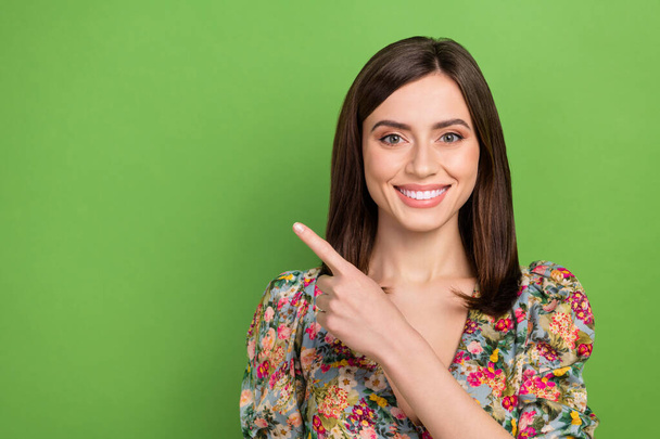 Portrait of lovely cute person beaming smile indicate finger empty space isolated on green color background. - Foto, afbeelding