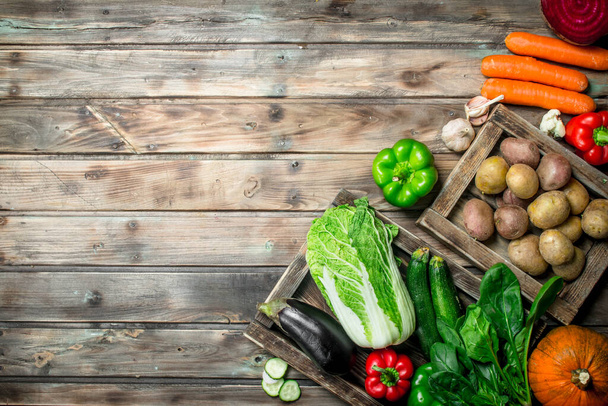 Healthy food. Assortment of fresh organic fruits and vegetables. On a wooden background. - Foto, immagini
