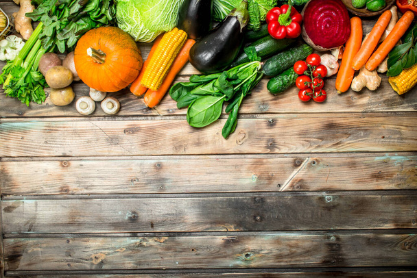 Healthy food. Variety of ripe fruits and vegetables. On a wooden background. - Foto, imagen