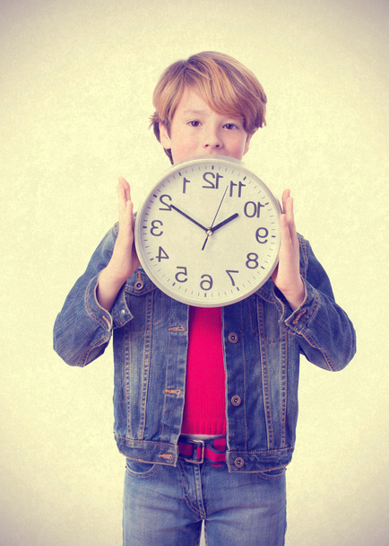 Boy holding a clock - Foto, immagini
