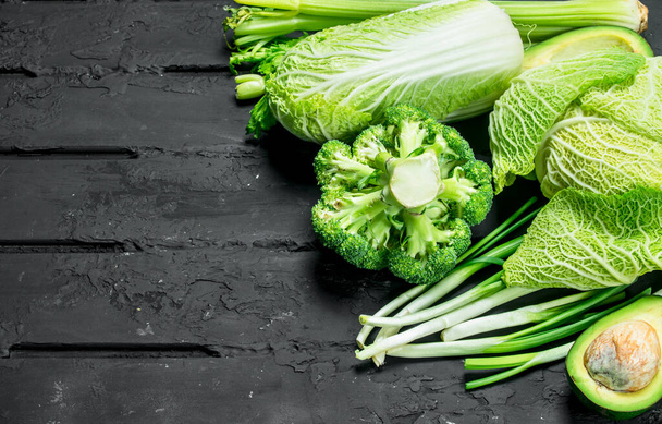 Organic food. Assortment of green healthy vegetables. On a black rustic background. - Foto, Bild