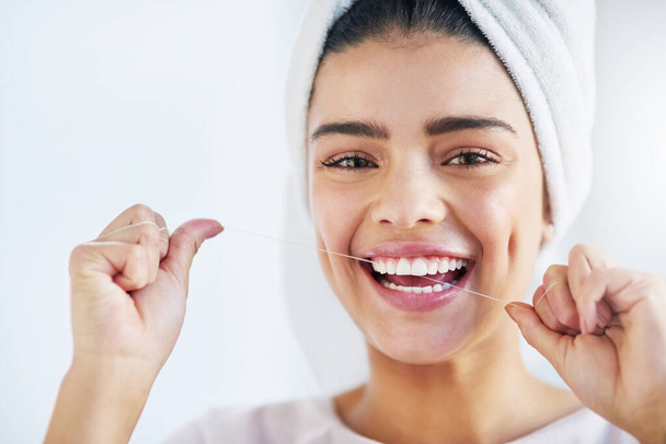 Portrait, happy and woman with floss, dental and oral health with happiness, cosmetics and fresh breath. Face, female person or girl in a bathroom, cleaning or self care with morning routine or teeth. - Photo, Image