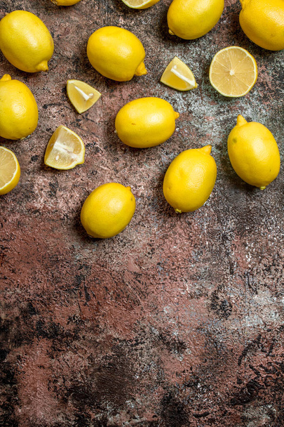 Fresh juicy lemons. On rustic background - 写真・画像