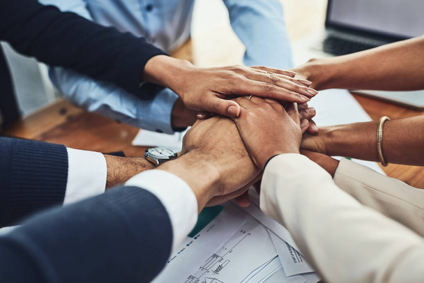 Hands together, business people in meeting and solidarity, support and team huddle with collaboration. Group of employees working in office, teamwork and mission with hand stack over paperwork. - Foto, afbeelding