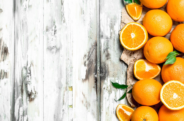 The smell of fresh oranges. On white wooden background - Photo, image