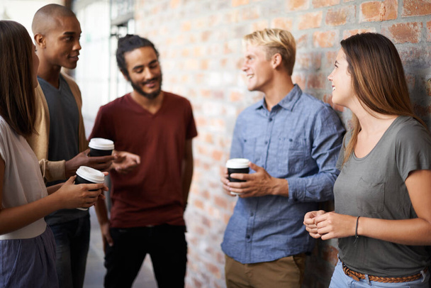 Coffee, friends and students talking in a college hallway for discussion, happiness and a drink. Group of diversity men and women at campus or university for conversation about education and learning. - Φωτογραφία, εικόνα