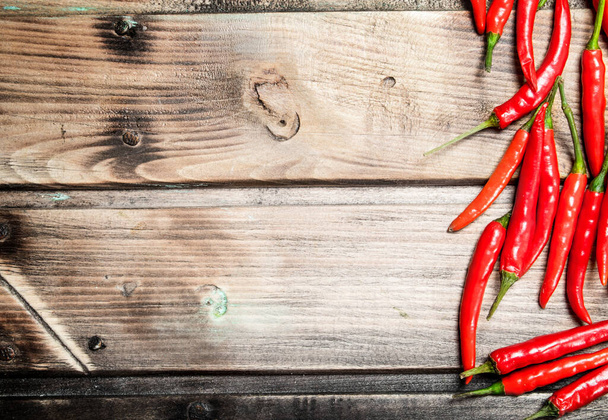 Ripe hot pepper. On wooden background - Foto, afbeelding