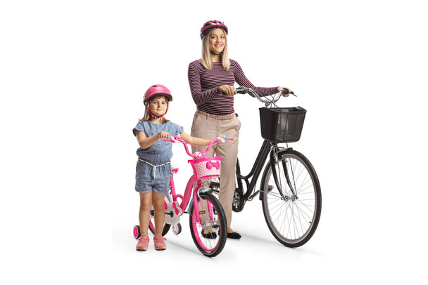 Child and mother wearing helmets and standing with bicycles isolated on white background - Foto, Imagen