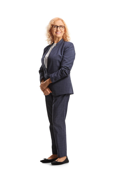 Smiling mature businesswoman in a navy color suit isolated on white background - Foto, immagini