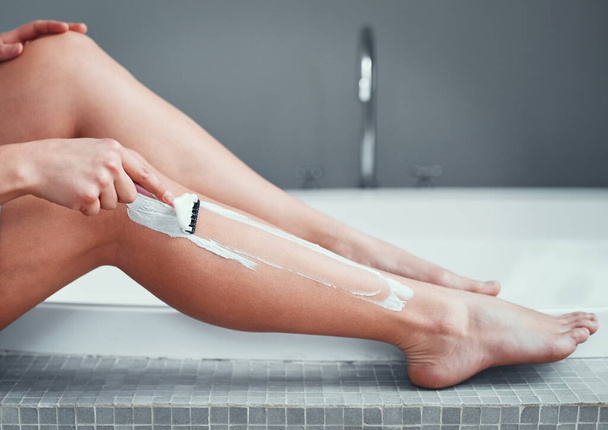 Legs, shaving razor and woman in home bathroom for hair removal, epilation and self care. Female person with hand for skincare, cleaning body and grooming with foam or soap for health and wellness. - Foto, Imagem