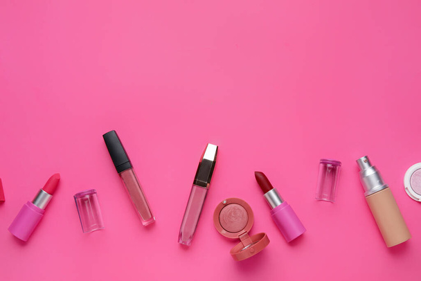 Decorative cosmetics with lipsticks on pink background - Zdjęcie, obraz