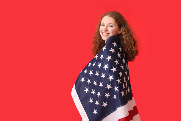 Young woman with USA flag on red background - Foto, immagini