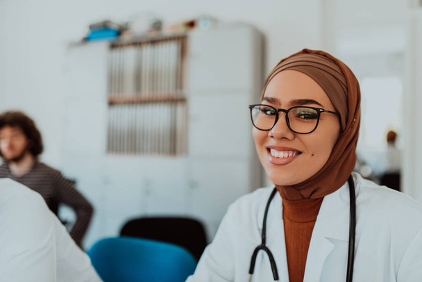 In a modern meeting room, a Muslim female doctor wearing a hijab engages in a discussion with her colleagues, exemplifying the power of diversity, inclusivity, and collaborative problem-solving in - Photo, Image