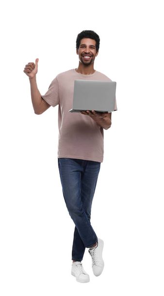 Happy man with laptop showing thumb up on white background - Фото, изображение