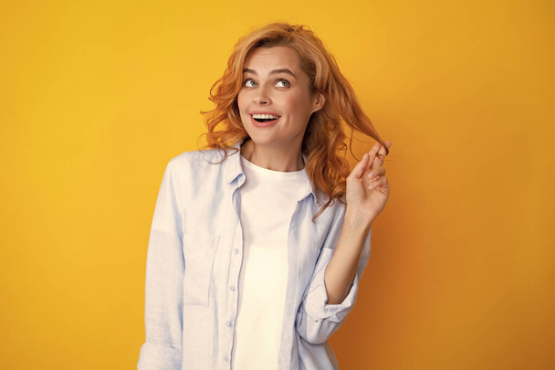 Redhead woman portrait. Beautiful redhead woman smiles cheerfully isolated on yellow background - Φωτογραφία, εικόνα