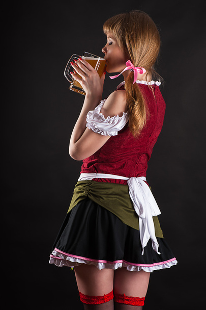 Sexy woman Oktoberfest drinks beer - Φωτογραφία, εικόνα