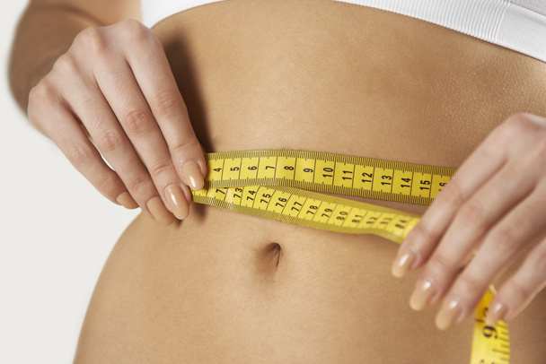 Close-Up Of Woman In Underwear Measuring Waist With Tape - Photo, Image