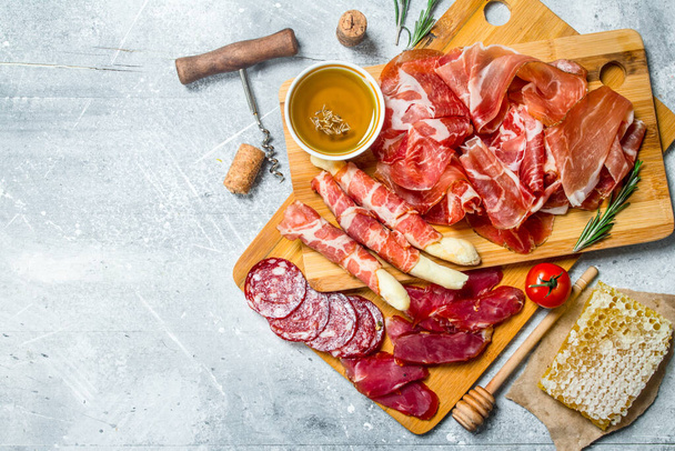 Antipasto background.The various meats. On a rustic background. - Φωτογραφία, εικόνα