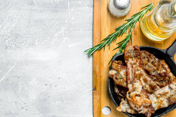 Fried bacon with spices. On a rustic background. - Photo, Image