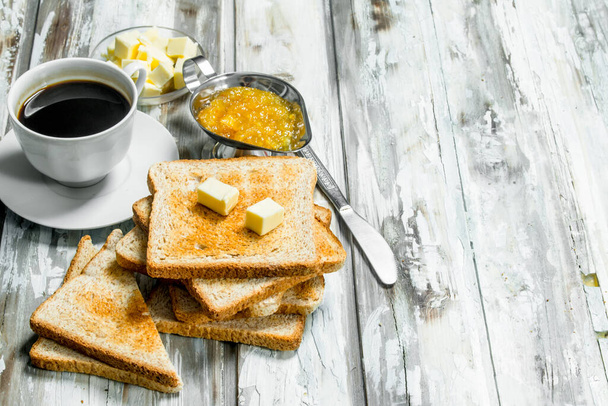 Breakfast. Toasted bread with butter and hot coffee . On Wooden rustic background. - Valokuva, kuva