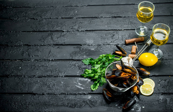 Fresh seafood clams with white wine. On black rustic background - Photo, Image