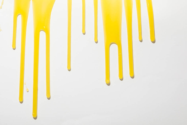 Drips of honey on white background, juicy honey on white background - Fotografie, Obrázek