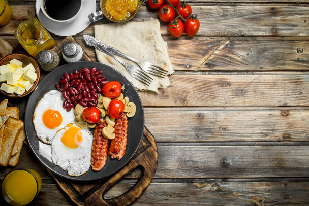 traditional English breakfast. Snacks with fresh coffee. On a wooden background. - Photo, Image